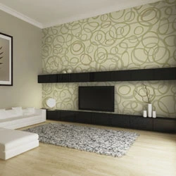 Modern living room with patterned wallpaper, black shelves, and a mounted flat-screen TV.